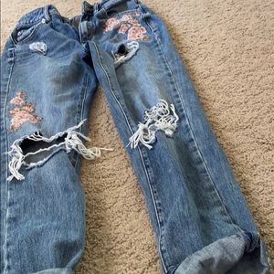 Floral appliqué and ripped denim